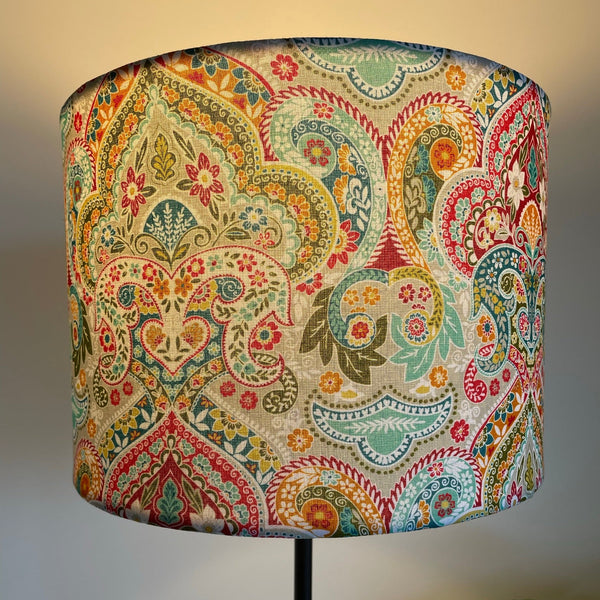 Decorative lampshade with a colorful paisley pattern on a plain background