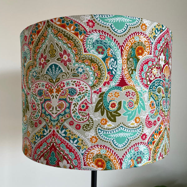 Decorative lampshade with colorful paisley pattern on a white background