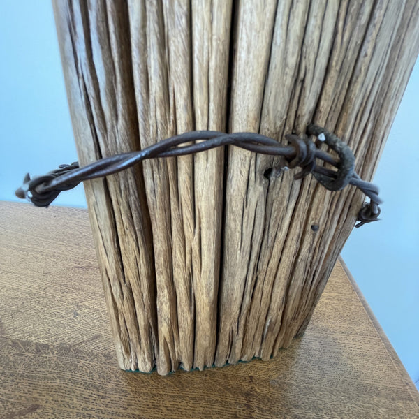 Wood table lamp handcrafted from vintage tōtara post with retained original barbed wire close up of front view. Made by shades at grays.
