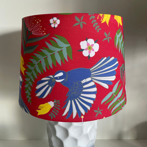 Jade Ell design on medium tapered lampshade with fantail dance on crimson red fabric, handcrafted by shades at grays, unlit.