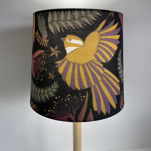 Jade Ell designed fantail dance on midnight black fabric on small tapered lampshade, handcrafted by shades at grays, lit.
