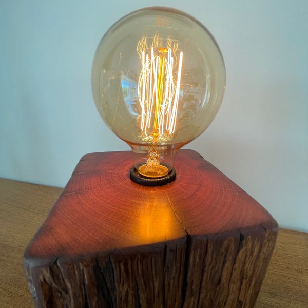 Jarrah wood table lamp handcrafted by shades at grays, close up of polished top.