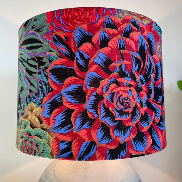 Red blooms on Kaffe Fassett House of Leeks Dark fabric on handcrafted medium drum lamp shade, made in nz by shades of grays.