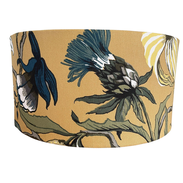 Large barrel lampshade with mustard floral fabric, centred on blue thistle 