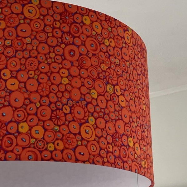 Large barrel lampshade with button mosaic orange fabric, close up, handcrafted by shades at grays.