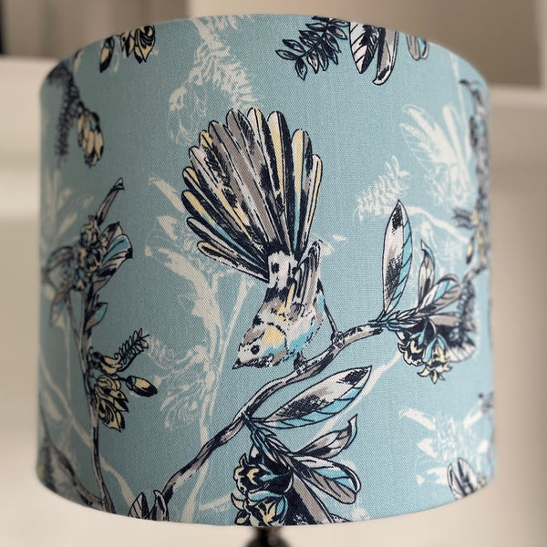 Lampshade with bird and floral pattern on a light blue background