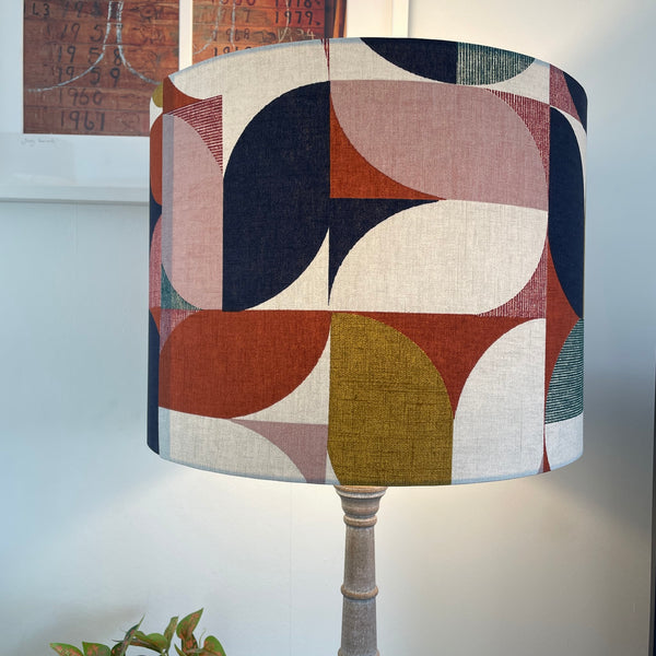 Large drum lampshade in bold and beautiful fabric based on geometric pattern, lit, handcrafted by shades at grays.
