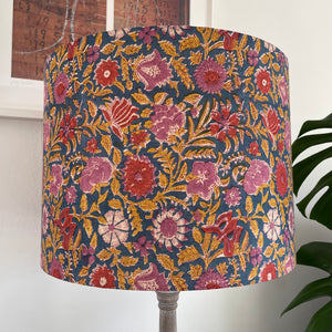 Large drum style lampshade with blue floral fabric with pink and red flowers, unlit, handcrafted by shades at grays.
