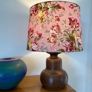 Large tapered handcrafted lampshade with tulip bouquet fabric on java wood lamp base, lit, sold by shades at grays.