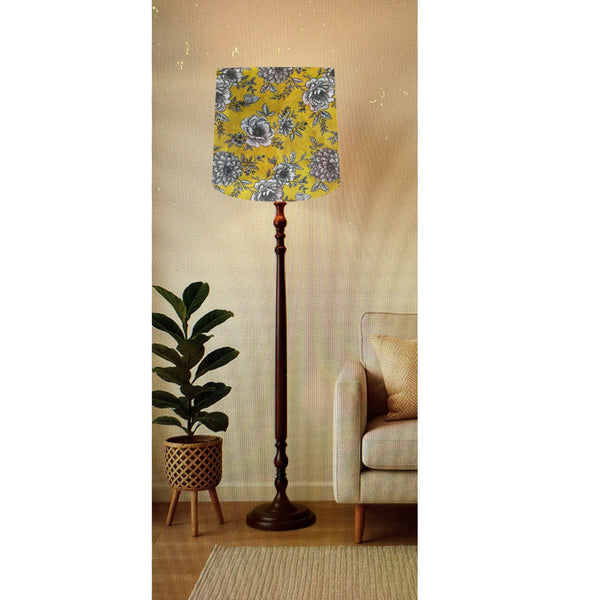Large tapered lampshade handcrafted by shades at grays with floral glow fabric on tall floor stand.