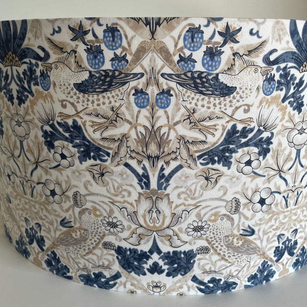 Large barrel lampshade by shades at grays with william morris strawberry thief vellum wandle fabric, front view, unlit.