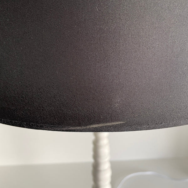 Large black drum lampshade with chalk like mark on exterior