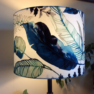 Large drum handcrafted fabric lamp shade with watermark palm fabric, lit.