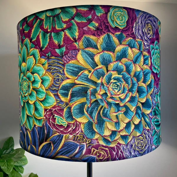 Large drum bespoke lamp shade made in nz by shades at grays using Kaffe Fassett House Leeks fabric grey, lit, blue leaves.