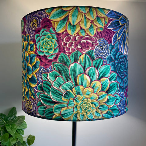 Large drum bespoke lamp shade made in nz by shades at grays using Kaffe Fassett House Leeks fabric grey, lit.