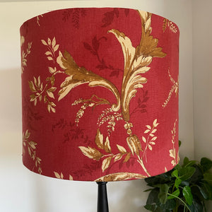 Large drum fabirc lamp shade made in nz by shades at grays, unlit, gold foliage on red print.