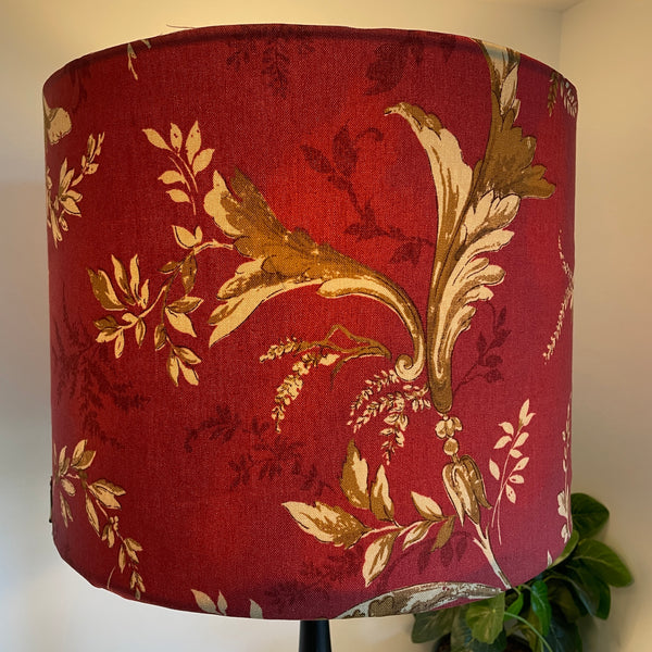 Large drum fabirc lamp shade made in nz by shades at grays, lit, gold foliage on red print.