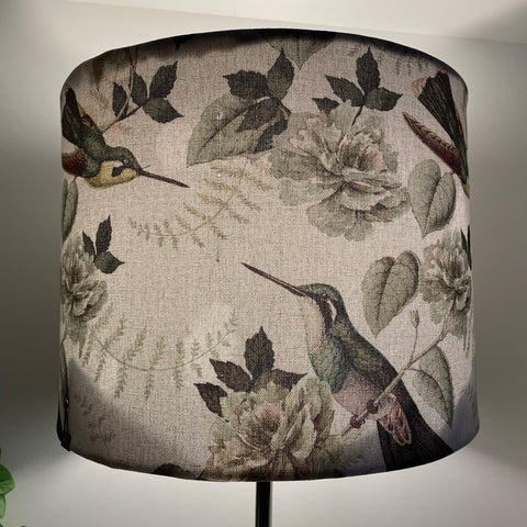 Large drum fabric lamp shade made in nz by shades at grays with hummingbird print, lit.