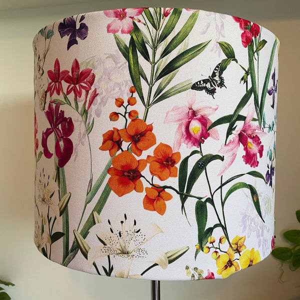 Large drum handcrafted fabric lamp shade made in nz by shades at grays using spring orchids fabric, with orange and pink flowers. 