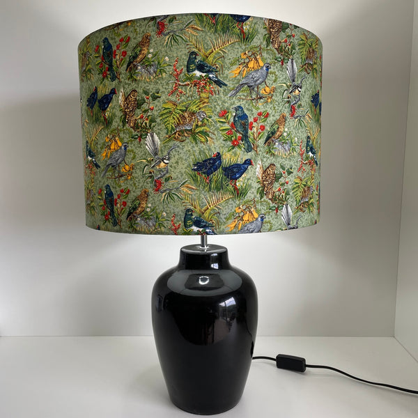 Large drum lampshade with kiwiana birds fabric, lit on black base