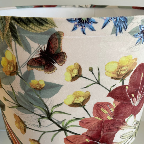 Large drum lampshade with velvet bouquet fabric, crease damage at the top, running from left to right.