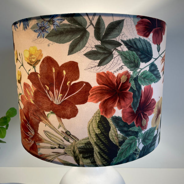Large drum lampshade with velvet bouquet fabric, ruby red blossoms, lit.