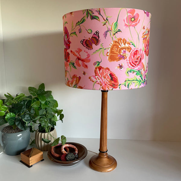 Drum light shade with Kaffe Fassett meadow pastel fabric, on wooden table lamp base unlit, by shades at grays, nz.