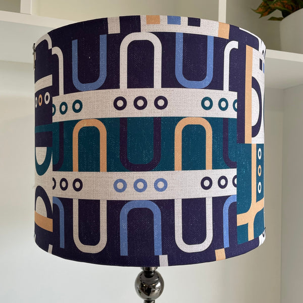 Large drum style lampshade with geometric harmony blue fabric, unlit, handcrafted by shades at grays, nz.