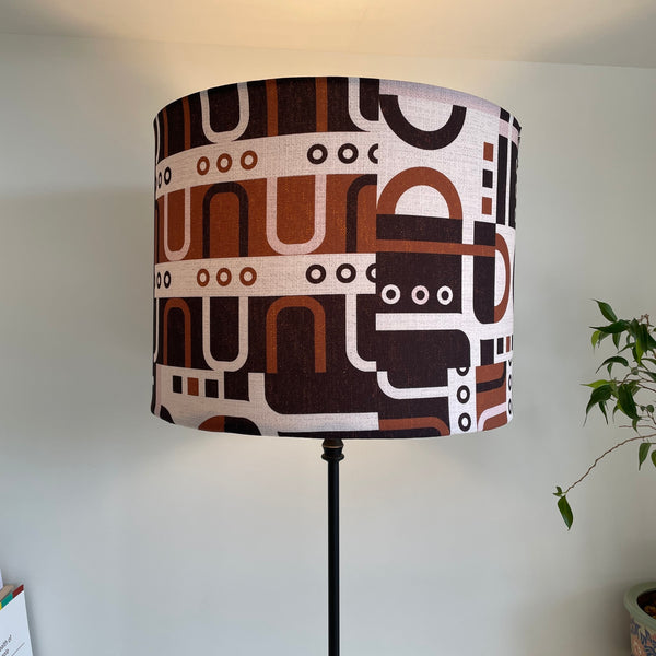 Large drum style lamp shade with geometric harmony tan, lit by shades at grays, nz