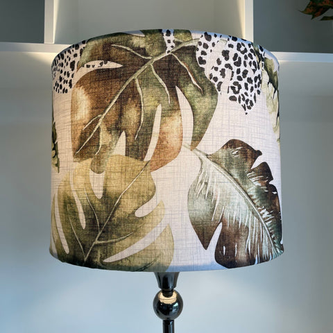 Large drum style light shade with jungle chic fabric, close up of green and brown monstera leaves and leopard print, made by shades at grays, nz