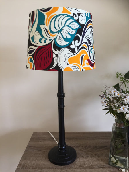 Large handcrafted fabric lamp shade by shades at grays on a black base