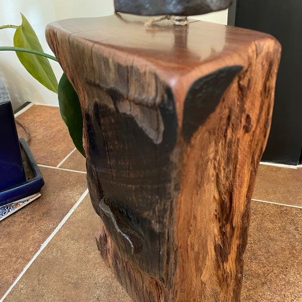 Large railway anchor on top of polished top of wharf timber door stop, close up of right side and front, crafted by shades at grays.