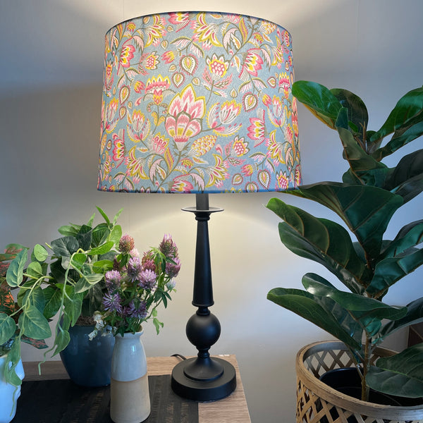 Large tapered hand crafted fabric lamp shade, lit by shades at grays.