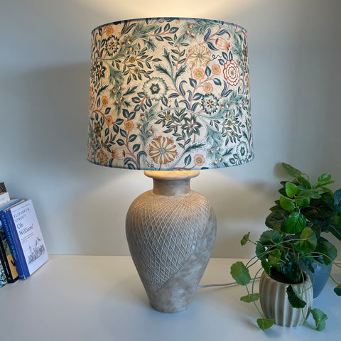 Large tapered lampshade with William Morris Orkney Wilhemina Linen fabric, lit, on large blush pink lamp base, shades at grays nz