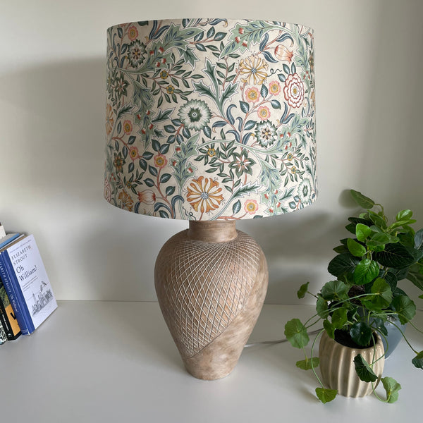 Large tapered lampshade with William Morris Orkney Wilhemina Linen fabric, unlit, on large blush pink lamp base, shades at grays nz