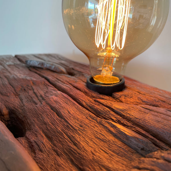 Large wood table lamp crafted by shades at grays from wharf timber top view of eroded markings.