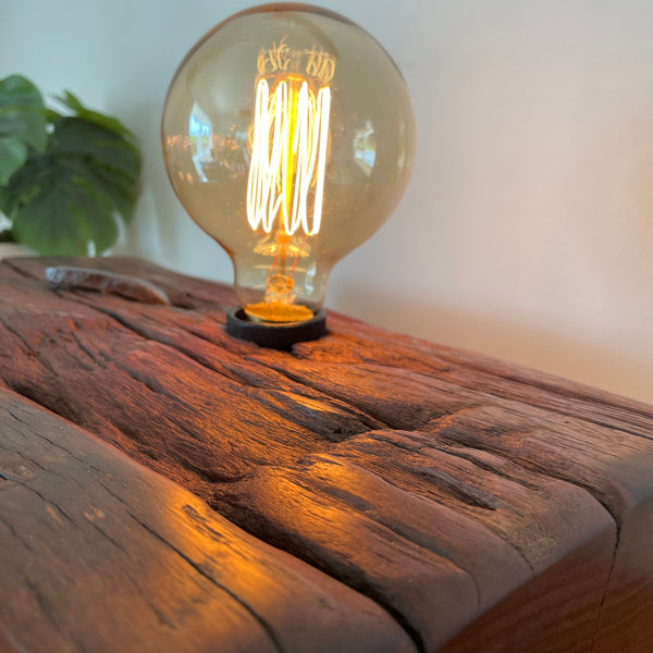 Large wood table lamp crafted by shades at grays from wharf timber with original nail and replica edison bulb, top view