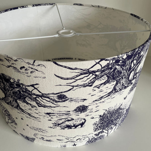 Large barrel ceiling lampshade with pastoral scene etched in ink blue on soft white textured background, frame suits standard NZ fittings.