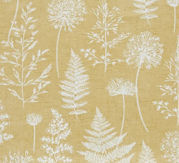 Close up of Meadow Mustard fabric: white silhouettes of ferns, seed heads and grasses on a warm mustard yellow background.