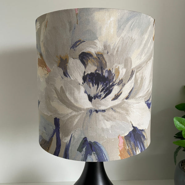 Medium cylinder lampshade with two tone roses blue fabric, unlit.