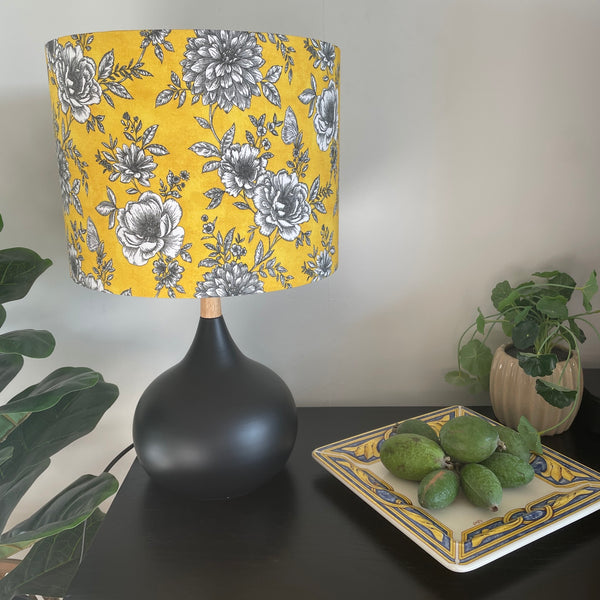 Medium drum handcrafted by shades at grays with floral glow fabric, unlit on black base.