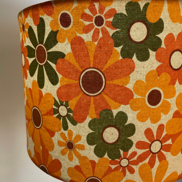 Medium drum handcrafted lampshade nz with mid century flower power fabric close up of orange and green stylalised flowers by shades at grays.