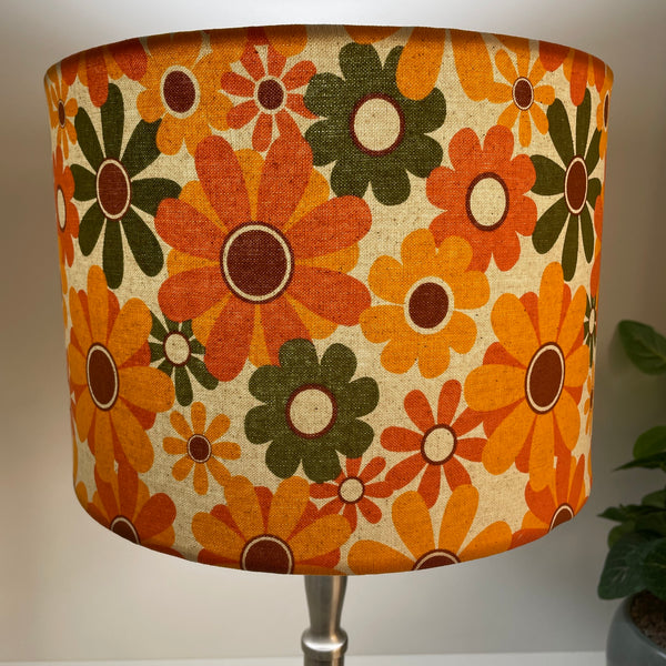 Medium drum handcrafted lampshade nz with mid century flower power fabric, lit by shades at grays.