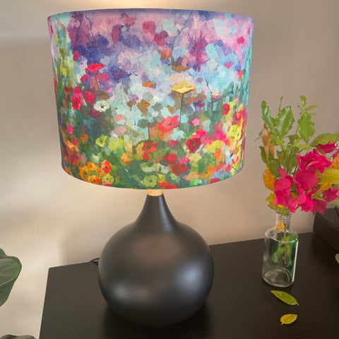 Medium drum lampshade handcrafted by shades at grays with garden envy fabric on black base.