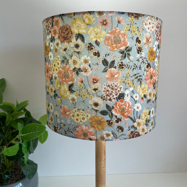 Medium drumshade floral mix fabric, lit, close up, sold by shades at grays. 