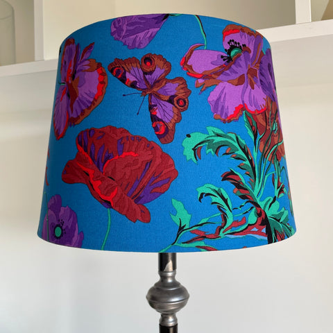 Medium tapered lampshade handcrafted by shades at grays with Kaffe Fassett teal meadow fabric, unlit.