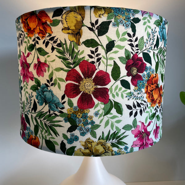 Medium drum bespoke lampshade with flower garden fabric, lit by shades at grays nz