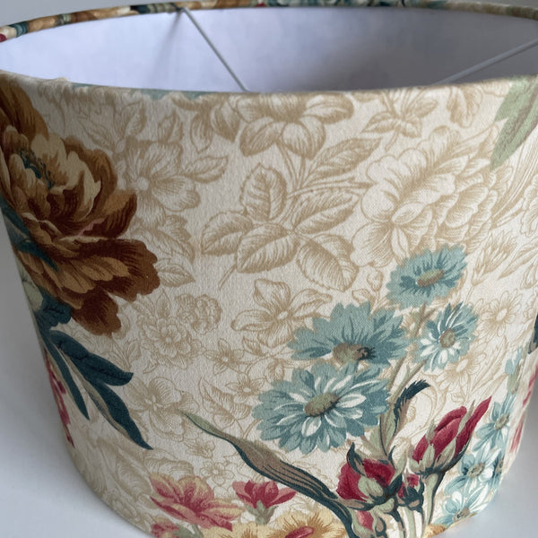 Medium drum ceiling lampshade in vintage floral fabric, blue daisies balance out large blooms, handcrafted by shades at grays.
