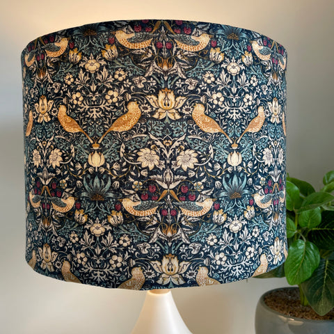 Medium drum lightshade with Strawberry Thief mini teal print, lit, by shades at grays nz.
