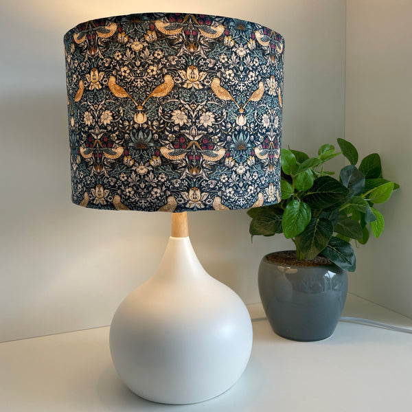 Medium drum lightshade with strawberry thief mini teal fabric on white base, lit by shades at grays nz.